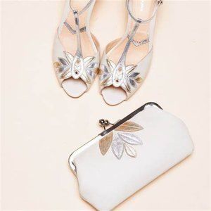 Ivory leather clutch with gold and silver detail and silver chain strap